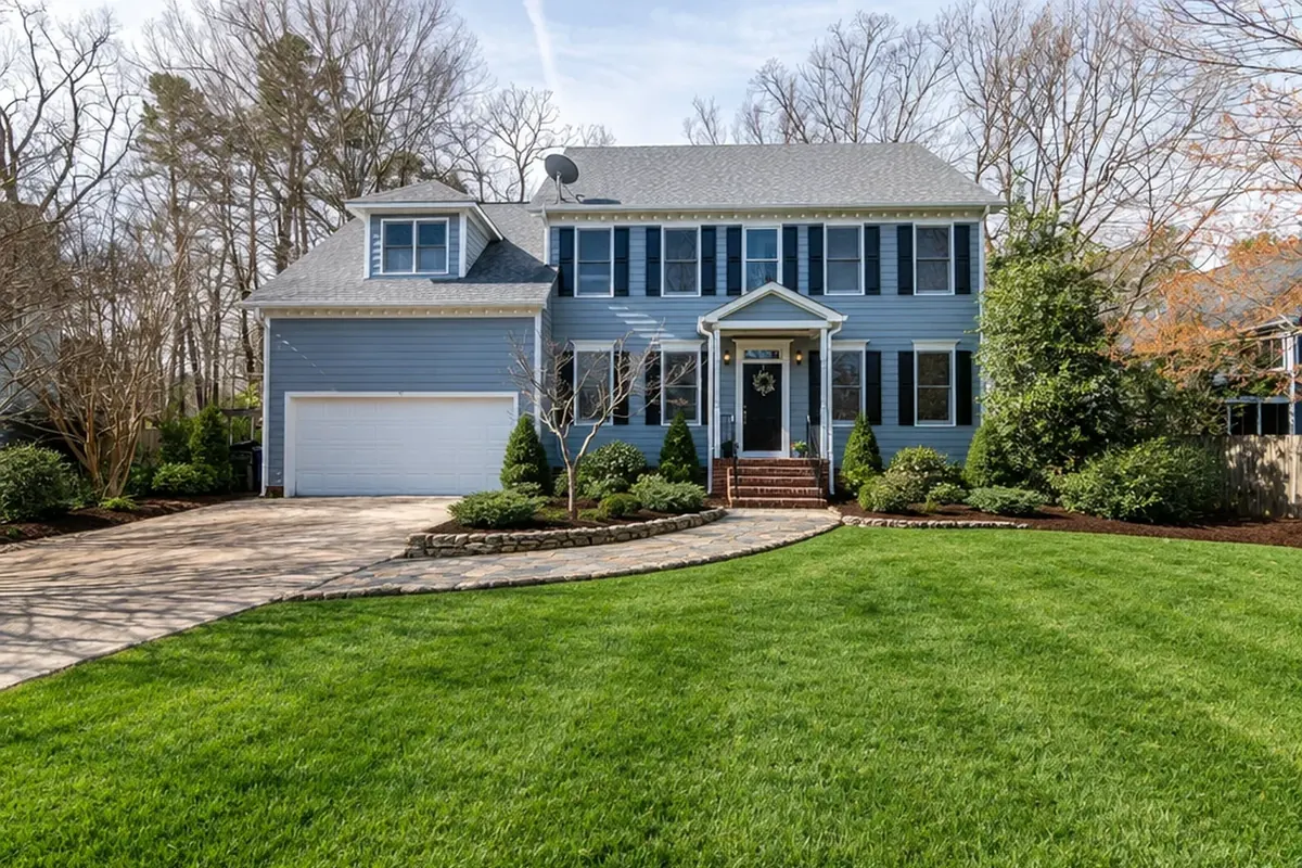 The same house with a stone entry path, foundation planting and cut-edged beds